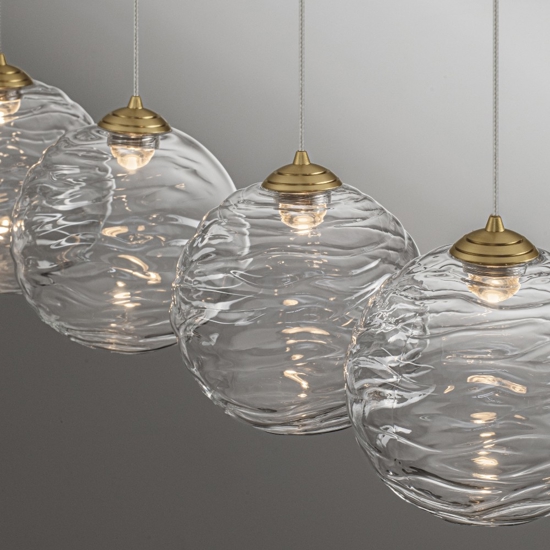 Lampadario oro con pendenti sfere di vetro ondulato trasparente per sala da pranzo