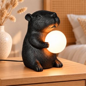 Abat-jour per comodino a forma di capibara nero con sfera in vetro bianco